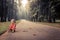 Lonely carefree child girl playing on road in park alone concept loneliness carefree childhood lifestyle