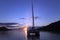 Lonely catamaran in a quiet lagoon at sunset