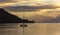 Lonely catamaran at sunset near Bora-Bora island