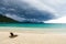 Lonely chaise longue on a deserted beach, against a background o