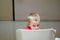 Lonely child and orphan waits scared in the chair of a waiting room