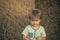 Lonely child. Unhappy child at hay bale, summer