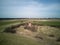 A lonely chimney and a stove in the middle of a field.