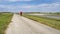 lonely cyclist is riding a gravel touring bike - biking on a levee trail along Chain of Rocks Canal