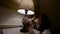 lonely and depressive woman is sitting alone at home at night, looking on table lamp light