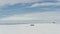 Lonely desolate log cabins at Canada's  Ivvavik NP coast in winter