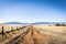 A lonely dirt road through the grasslands along the border between the United States and Mexico