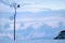 Lonely dry tree and raven against the background of dawn clouds. Landscape in a minimalist style. Lake Baikal. Russia.