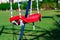 Lonely empty children`s swing on grass background