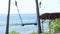 Lonely empty Swing On The Nature Background. Tropical island Bali, Indonesia. Near the beach with black sand. Amazing