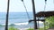 Lonely empty Swing On The Nature Background. Tropical island Bali, Indonesia. Near the beach with black sand. Amazing