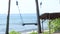 Lonely empty Swing On The Nature Background. Tropical island Bali, Indonesia. Near the beach with black sand. Amazing