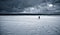 A lonely figure in a snow-covered frozen lake.