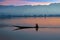 Lonely fisherman fishing at sunrise on a lake in Myanmar