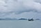 Lonely fishing boat at anchor on bay with mountain background