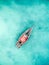 Lonely fishing boat in clean turquoise ocean, aerial photo