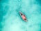 Lonely fishing boat in clean turquoise ocean, aerial photo