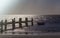 Lonely fishing boat and sea pier in dark ocean, sea.