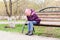 Lonely girl crying covering her face with palms on a park bench. Mental health. Teenage years