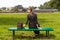 Lonely girl in a dress on a park bench, enjoys a vacation.