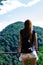 A lonely girl looks at the mountains on the other side. Low lying clouds and mountains