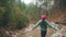 Lonely girl in red hat rejoicing at end of walking route. Happy woman resting after hiking or trekking outdoor. Female