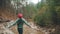 Lonely girl in red hat rejoicing at end of walking route. Happy woman resting after hiking or trekking outdoor. Female