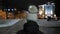 Lonely girl walking on snow. Night city, 4K UHD