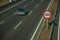 Lonely grey car on highway and SPEED LIMIT signpost in Madrid