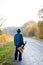 Lonely guitarist looking at empty country road in