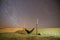 Lonely hammock next to dunes on Sahara desert with amazing starry sky above, Morocco