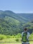 Lonely hiker tourist enjoing mounain view in sunny summer day