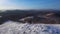 Lonely hiker walks along the top of a mountain range.