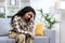 Lonely hispanic woman sitting alone on sofa in living room at home, depressed woman thinking about difficult decision