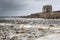 Lonely house coastline in France on a stormy day, low tide with