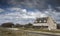 Lonely house coastline in France on a stormy day, low tide with