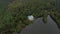 Lonely house on the lake in the forest top view