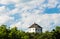 Lonely house on top of hill with blue sky