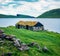 Lonely house with turf-top on the coast of Sorvagsvatn lake, Vagar island. Gloomy morning view of Faroe Islands, Kingdom of Denmar