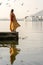 Lonely indian woman in a beautiful dress looks at the lake in Udaipur, Rajasthan, India