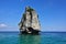 Lonely island in the Andaman Sea. A rock in the form of a pyramid rises high above the turquoise water.