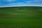 A lonely island with an old tool shed for working in the field in the middle of the Moravian green fields