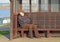 Lonely isolated man on coastal bench