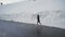 Lonely jogger with bright pink running shoes sprinting in snow corridor in Bulgarian mountains