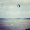 A lonely kite surfer surfing the waves of the sea Ã–resund between Sweden and Denmark