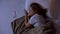 Lonely lady lying in bed, looking at smartphone, waiting for sms from boyfriend