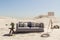 lonely living room couch in large desert environment immersion entertainment movie concept 3D illustration