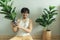 Lonely man being friend with his tree plant in the apartment.