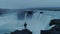 Lonely man at epic icelandic waterfall at dusk