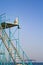 A lonely man sits on a rescue tower on the seashore on a sunny spring day